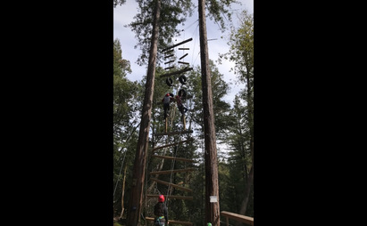 Ninth graders climbing a vertical obstacle course