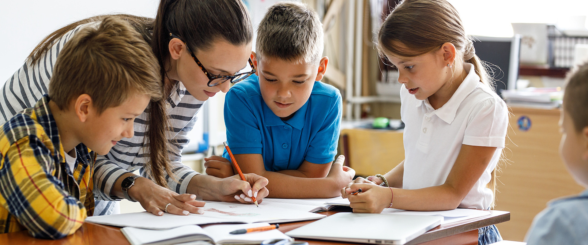 Teacher helping students